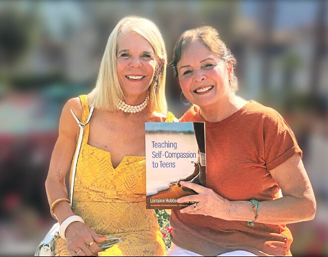 Image of people holding a book